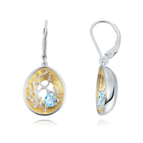 Beautiful artisan made light blue topaz, silver and gold earrings as a gift for you or a loved one. Main Stone: Topaz. Metals Type: 925 Sterling Silver and Gold Plated. Earring Type: Drop Earrings.