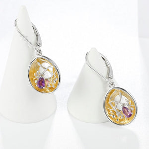 Beautiful artisan made purple topaz, silver and gold earrings as a gift for you or a loved one. Main Stone: Topaz. Metals Type: 925 Sterling Silver and Gold Plated. Earring Type: Drop Earrings.