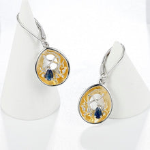 Load image into Gallery viewer, Beautiful artisan made dark blue, silver and gold earrings as a gift for you or a loved one. Main Stone: Topaz. Metals Type: 925 Sterling Silver and Gold Plated. Earring Type: Drop Earrings. 
